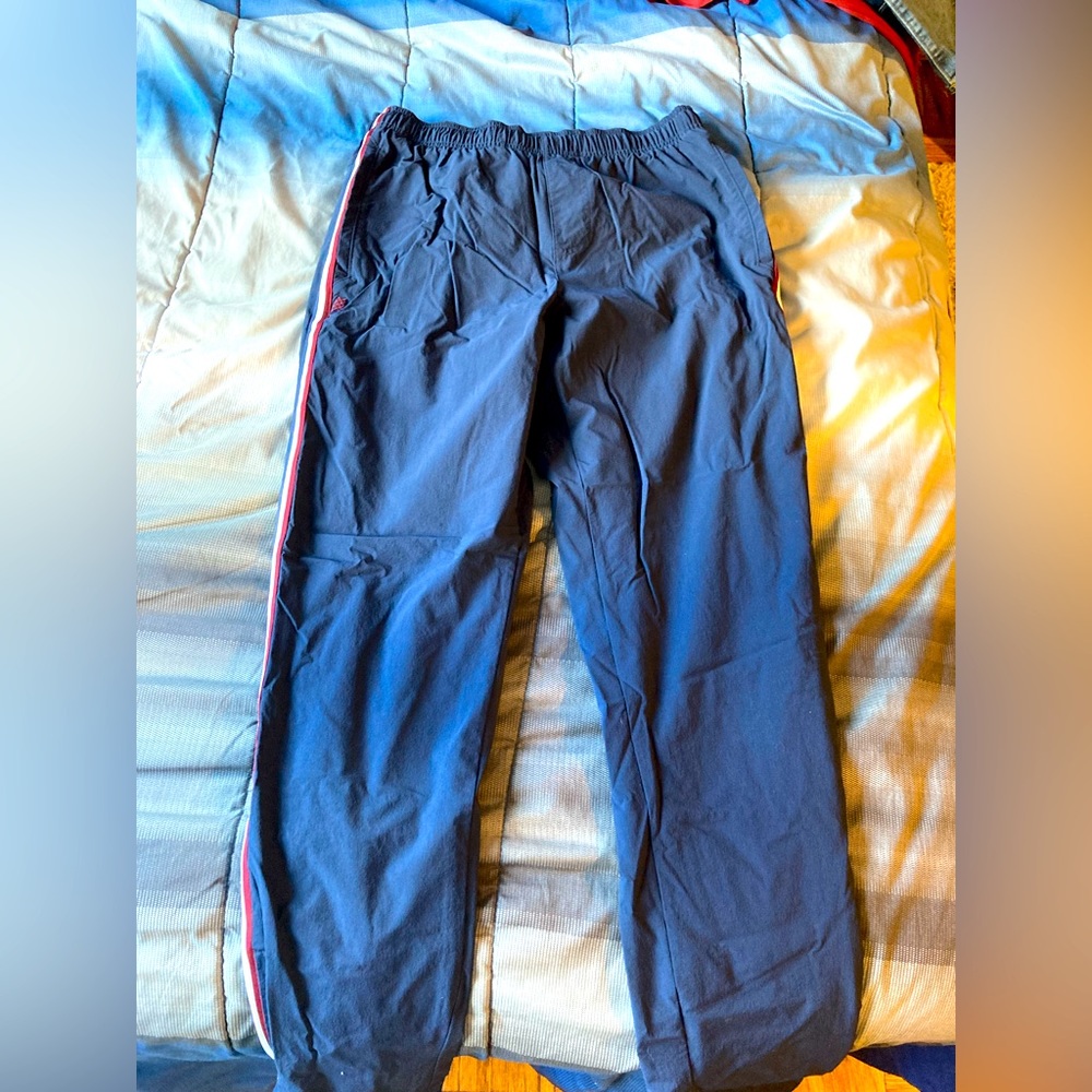 Rhone track pants, medium, navy blue with red and white stripe on the side